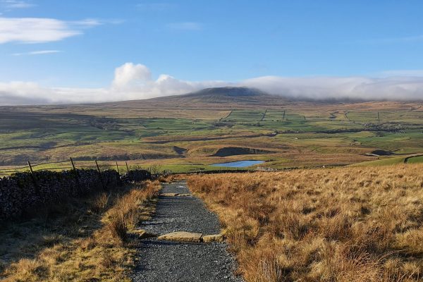 View overlooking a Tarn near Newhouses on the Y3P route. Ingleborough in the distance.
